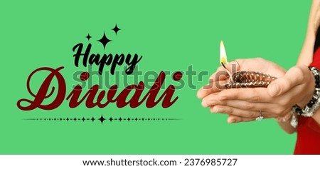 Greeting banner for Diwali (Festival of lights) with Indian woman holding diya lamp on green background