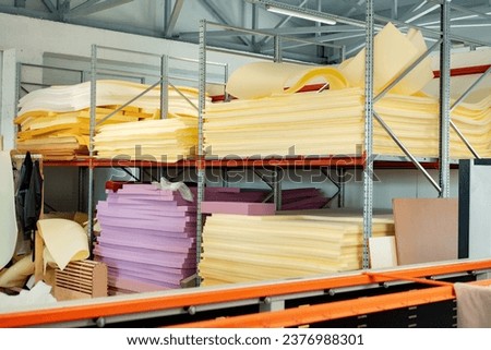Stacked sheets of foam rubber for furniture production in factory workshop