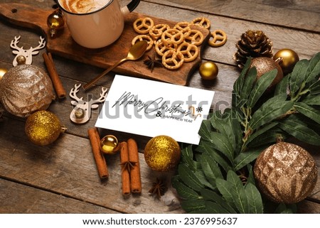 Beautiful Christmas composition with greeting card and decor on wooden background