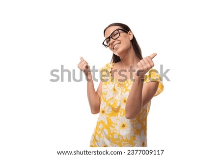 attractive young woman with glasses for vision correction shows class with her hand