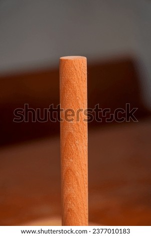 Small rolling pin made of wood tool for baking bread dough standing