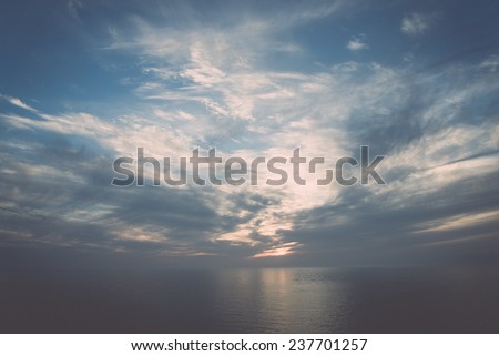 blue sky with white clouds closeup over the sea - retro, vintage style look