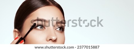 Beauty woman applying black mascara on eyelashes with makeup brush. Eyelash extensions. makeup, cosmetics. beauty, skincare Royalty-Free Stock Photo #2377015887
