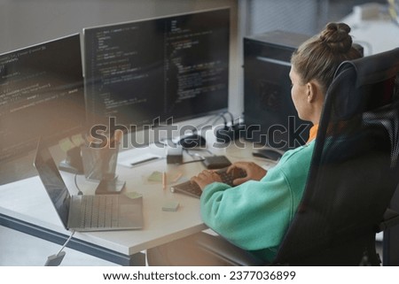 Woman working with security code on computer Royalty-Free Stock Photo #2377036899