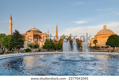 Fountain at Sultanahmet Square and the Hagia Sophia in Istanbul, Turkey. The Sultanahmet Square is a popular tourist attraction of Istanbul. Royalty-Free Stock Photo #2377041045