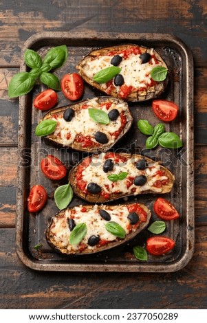 Healthy Eggplant or Aubergine pizza with tomato sauce, mozzarella cheese, basil and olives Royalty-Free Stock Photo #2377050289