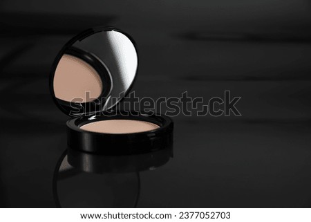 Open face powder on black mirror surface, closeup. Space for text Royalty-Free Stock Photo #2377052703