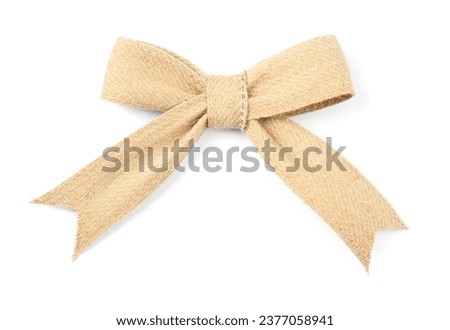 Bow made of burlap fabric isolated on white, top view Royalty-Free Stock Photo #2377058941