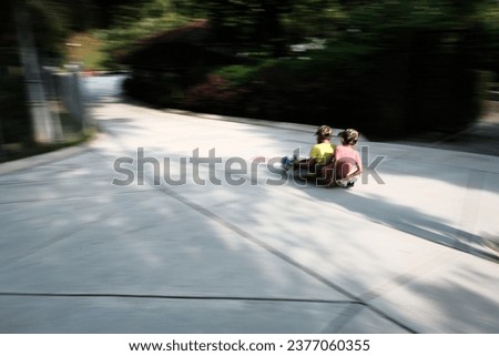 Motion blur picture of unrecognisably kids with a skate board