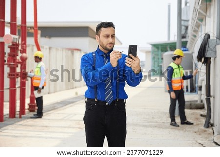 businessman working on smartphone at construction site