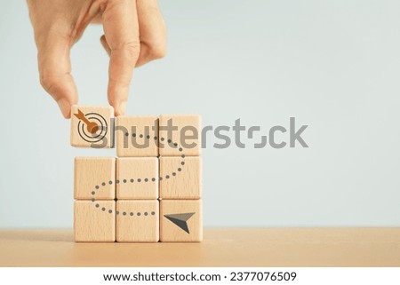 hand completed wooden cube blocks arrow route to dartboard. Business achievement goal and objective target. Growing business success concept.  Royalty-Free Stock Photo #2377076509