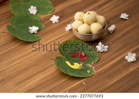 Indian festival dussehra , green leaf, rice and flowers Royalty-Free Stock Photo #2377077693