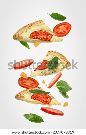 Falling slice of pizza with ingredients isolated