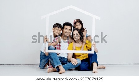 Roof, portrait and happy family with home sign board while sitting in the living room of their home. Happiness, protection and children with parents relaxing together with mortgage or house insurance