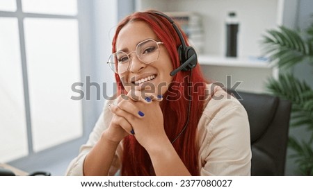 Irish charm at work, joyful redhead woman mastering the art of online support, spreading cheer at office with headset on