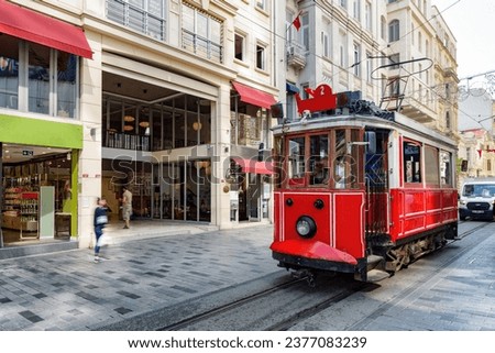 The Istanbul nostalgic tram on Istiklal Avenue. The historic tram is a popular tourist attraction. Awesome view of the street on sunny day. Royalty-Free Stock Photo #2377083239