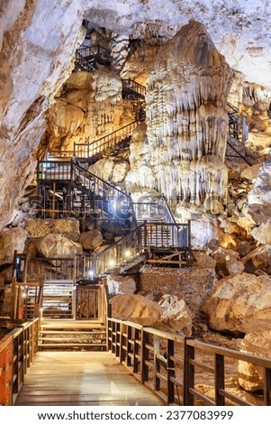 Wooden stairs leading to exit from Paradise Cave (Thien Duong Cave) at Phong Nha-Ke Bang National Park in Vietnam. Paradise Cave is a popular tourist attraction of Asia. Royalty-Free Stock Photo #2377083999
