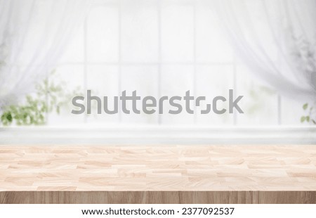 Selective focus.Wood table counter on blur curtain window in morning cozy home background.For montage product display or design key visual Royalty-Free Stock Photo #2377092537