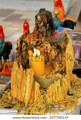 a candle is lit inside a tree stump.