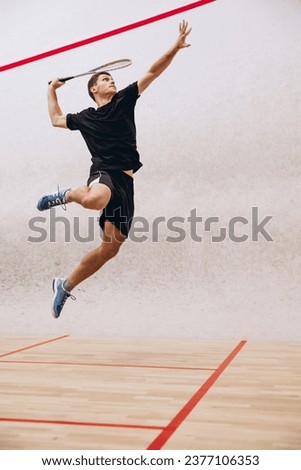 Portrait of sportive boy training, playing squash in sport studio. Sportive and active lifestyle. Concept of active life, team game, energy, sport, competition. Copy space for ad Royalty-Free Stock Photo #2377106353