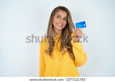 Close up photo of optimistic Young beautiful woman hold card