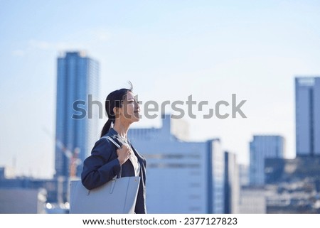 Japanese business looking into the distance in the business district Royalty-Free Stock Photo #2377127823