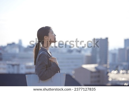 Japanese business looking into the distance in the business district Royalty-Free Stock Photo #2377127835