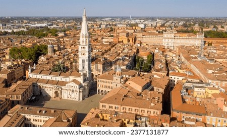 Aerial view of the Modena Cathedral and Torre della Ghirlandina, the bell tower of this Roman Catholic church. In background there is the Ducal Palace of Modena, Emilia Romagna, Italy. Royalty-Free Stock Photo #2377131877