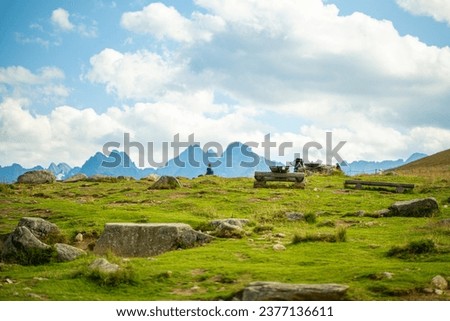 Rusinowa Glade, a serene spot in Tatra National Park, comes alive in summer. A local highlander herds sheep amidst the stunning vistas, offering an authentic glimpse into the region's traditions. Royalty-Free Stock Photo #2377136611