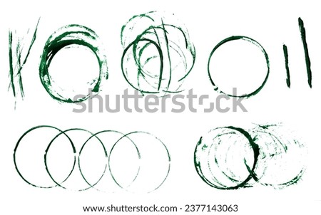 Round prints of green acrylic paint with drops on a white isolated background