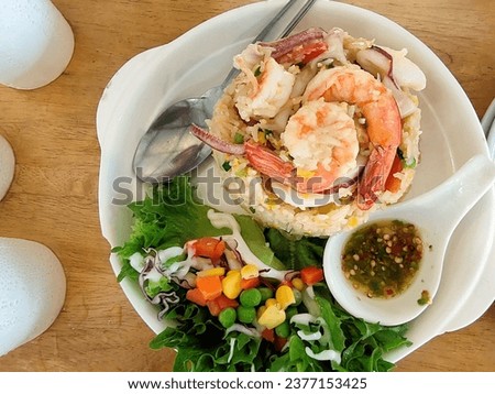 The photo as Thai food special menu.  Name's Shrimp Fried Rice to tasty or delicious for eat and very well background. Beauty photo and very nice picture of Thai sea food and fried rice.