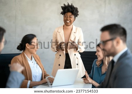 Multicultural professional businesspeople working together on research plan in boardroom. Royalty-Free Stock Photo #2377154533
