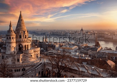 The Fisherman's Bastion from above with Hungarian Parliament building and River Danube during a golden sunrise in Budapest Royalty-Free Stock Photo #2377159729