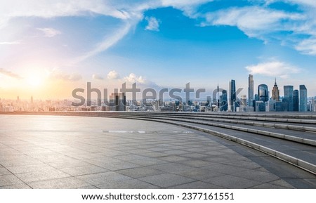 City square and Guangzhou skyline with modern buildings at sunset, Guangdong Province, China. 