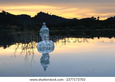 Sinking Buddha statue (Drowning Buddha) and reflection.
A large Buddha statue in the middle of the lake.
Phra Phuttha Siri Phuwadon Mongkonchai,
Khao Ra-Kham Reservoir ,Trat province ,Thailand 