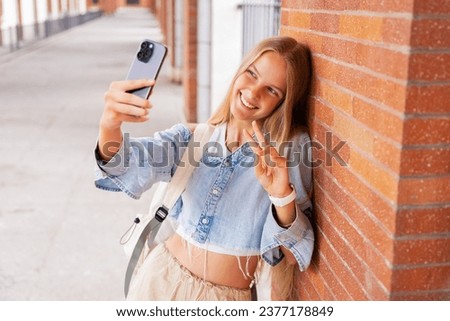 Girl taking selfie photo with a phone