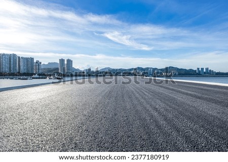 Straight asphalt highway and skyline under blue sky Royalty-Free Stock Photo #2377180919