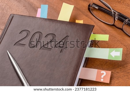 Notebook on a desk 2024 Royalty-Free Stock Photo #2377181223