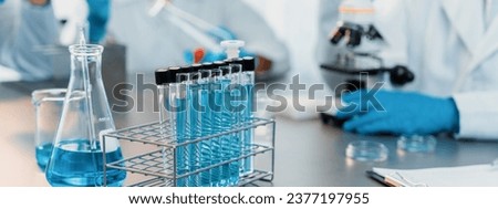 Chemical experiment test tube or medical equipment in laboratory on blurred background of scientist researching vaccine drug or antibiotic. Pharmaceutical and biochemistry lab. Neoteric