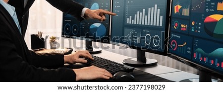 Analyst working on data analysis or BI dashboard on computer monitor. Business team analyzing financial data by Fintech in corporate office for business marketing and strategy planning. Trailblazing