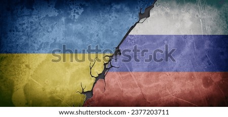 Concept of armed conflict between ukrainians and russians with dirty and deteriorated cement wall with flags painted and break in the center dividing both paintings.