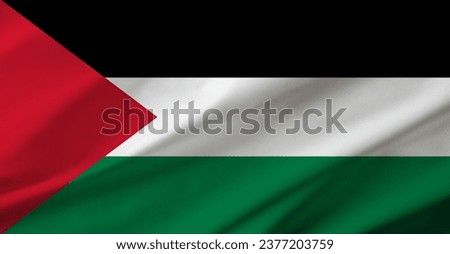 Background detail of Palestinian flag occupying the entire frame with waving fabric texture.