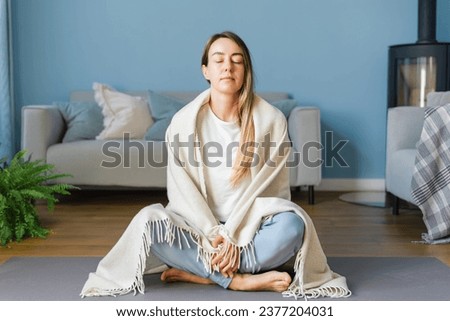 Young woman practicing meditation self care at home. Concept of mental health and women's wellness, mindfulness. Royalty-Free Stock Photo #2377204031