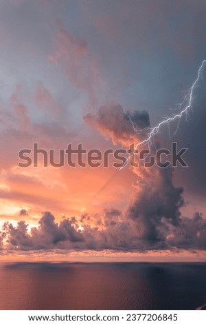 Sunset after storm with lightning falling towards the sea