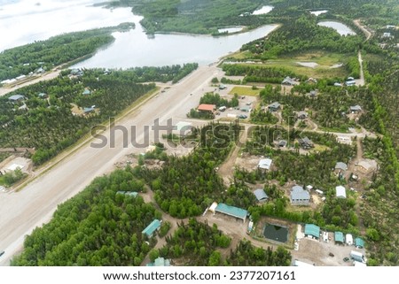 Aerial view of Port Alsworth, Alaska within Lake Clark National Park and Preserve. Private Port Alsworth Airport, public Wilder Natwick Airport, Hardenburg Bay. Royalty-Free Stock Photo #2377207161