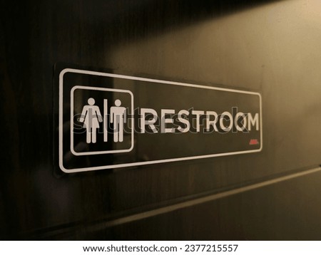 a restroom sign on a door 
