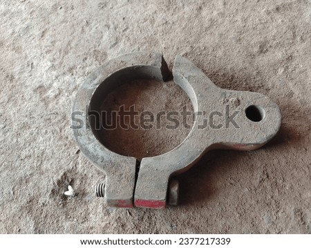 Top view of vintage rusty 316L metal iron ferrule tri-clamp on the ground. Rusty Tri-Clamp Ferrule on a white background Royalty-Free Stock Photo #2377217339