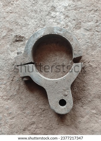 Top view of vintage rusty 316L metal iron ferrule tri-clamp on the ground. Rusty Tri-Clamp Ferrule on a white background Royalty-Free Stock Photo #2377217347