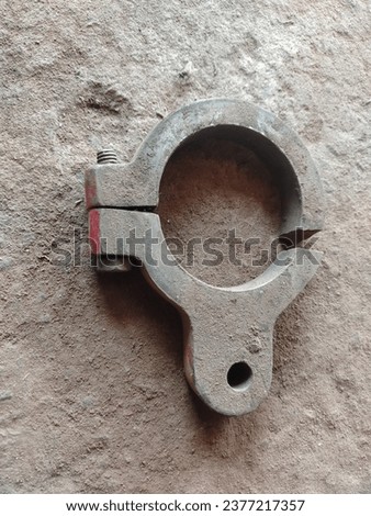 Top view of vintage rusty 316L metal iron ferrule tri-clamp on the ground. Rusty Tri-Clamp Ferrule on a white background Royalty-Free Stock Photo #2377217357