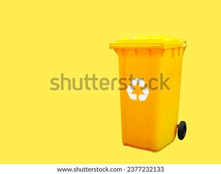 Recycle yellow bin with recycle sign, Separation recycle bin container for disposal garbage waste and save environment isolated on yellow background, Clipping path included.Copy space.